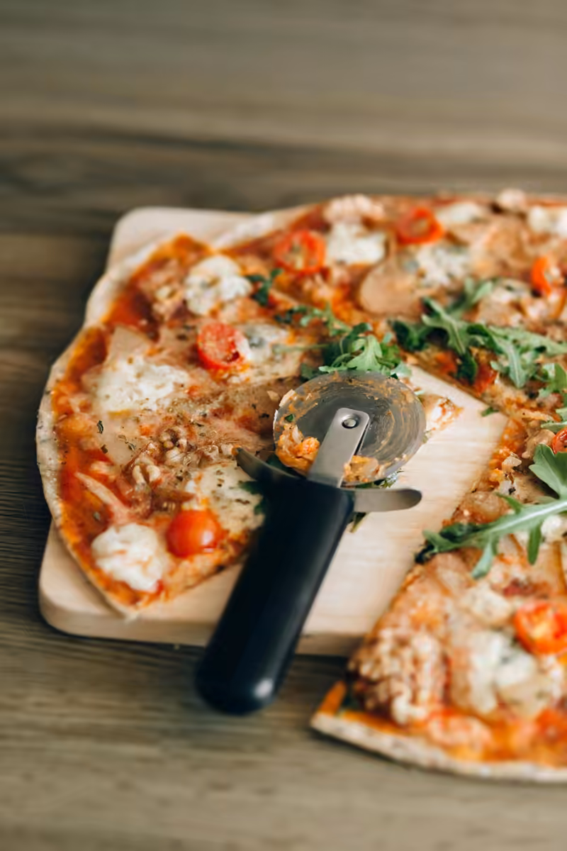 Catering spread at a Pizzeria Grande event — trays of pizza, pasta, and salads